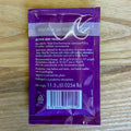 A purple packet of fermentis SafAle W-68 Active Dry Yeast placed flat on a light wood surface. The packet contains product details, a barcode, and a white SafAle logo.