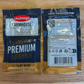 Two Lallemand Farmhouse Premium Series hybrid saison-style yeast packets shown side by side on a light wood surface, with the front and back packaging visible.