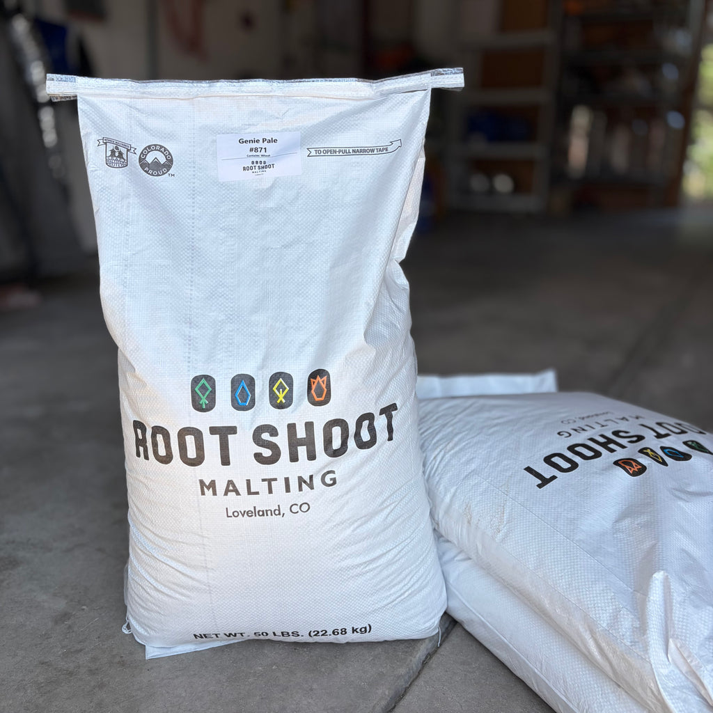 A bag of root shoot malting genie pale ale sack with other grain bags nearby in a garage setting
