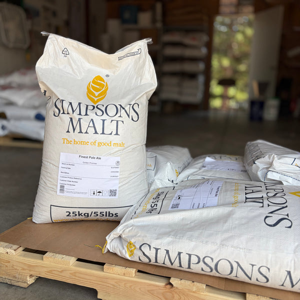 A pallet of Simpsons finest pale ale golden promise sacks with one bag standing up showing the label in a garage setting