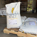 A pallet of Simpsons finest pale ale Maris otter sacks with one bag standing up to show the label in a garage setting