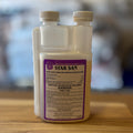A 16 oz container of star San on a wooden table with a blurred background
