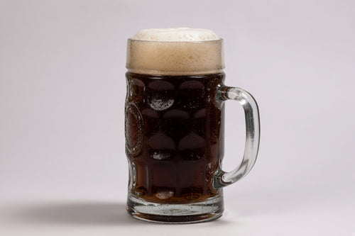 a mug glass of brown beer showing 34 srm color with a large tan head made with proximity regenmalt brown malted barley