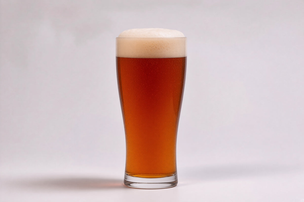 a pint glass of amber beer with a tan head made with root shoot honey malt