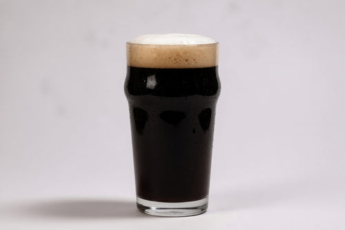a pint glass of black beer showing 40 srm color with a tan head made with weyermann carafa special type 1 malted barley