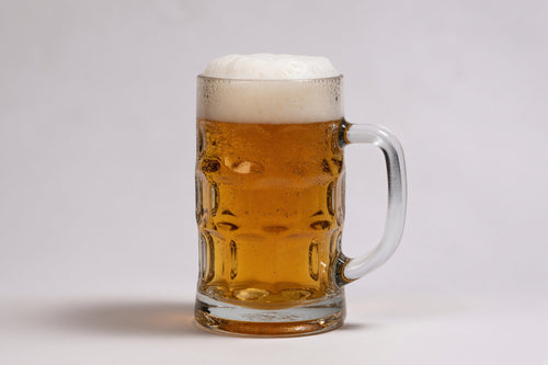 a glass mug of deep golden beer showing 15 srm color with a white head made with weyermann caramunich type 3 malted barley